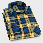 Folded blue and yellow plaid shirt on a white background
