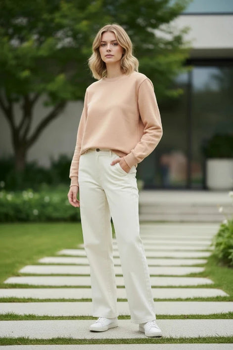 A plain crewneck sweatshirt in a warm beige or light tan color, 
