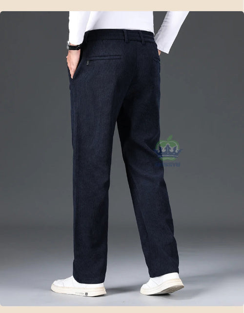 Dark blue pants worn by a person on a gray background