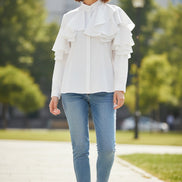 White blouse with ruffled details on a white background