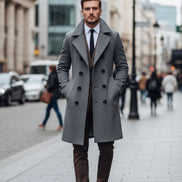 Man wearing a gray coat and brown vest on a city street
