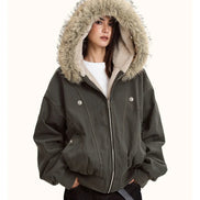 Person wearing a dark gray jacket with a fur-lined hood on a white background