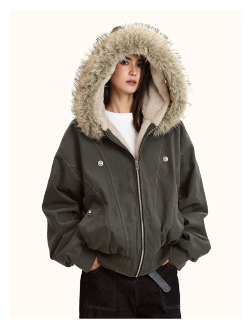 Person wearing a dark gray jacket with a fur-lined hood on a white background
