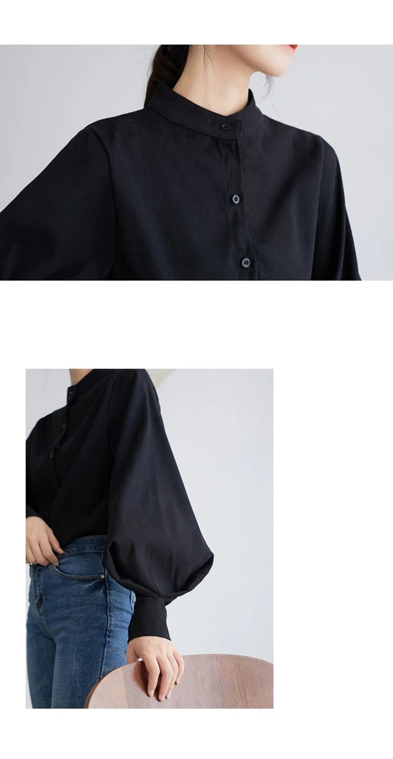 Black shirt worn by a person on a plain background