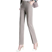 Gray pants worn with a plaid jacket on a white background