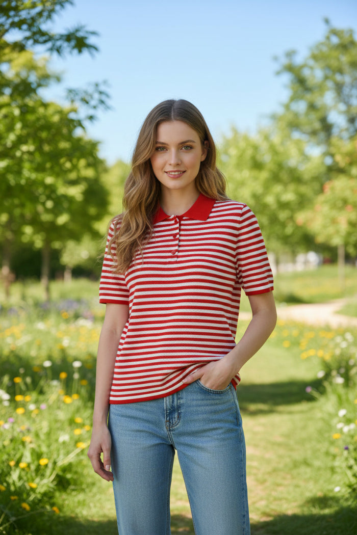 A red and white horizontally striped short-sleeve polo shirt with a solid red collar, hanging on a wooden hanger from a rustic branch. The image has a white border with red Chinese text in the top left reading '红色条纹' (Red stripes) and a small magazine prop on a white table at the bottom right.