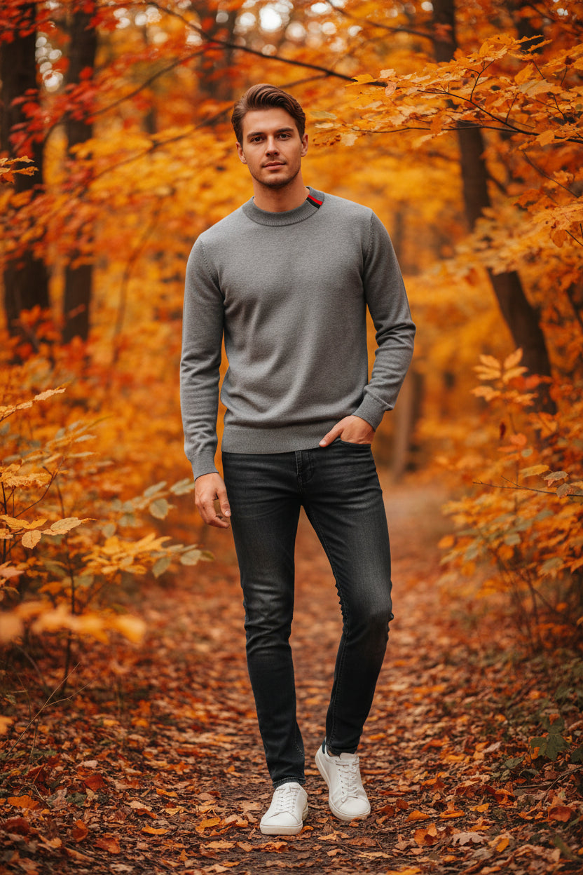 Gray sweater with a watch on a dark surface