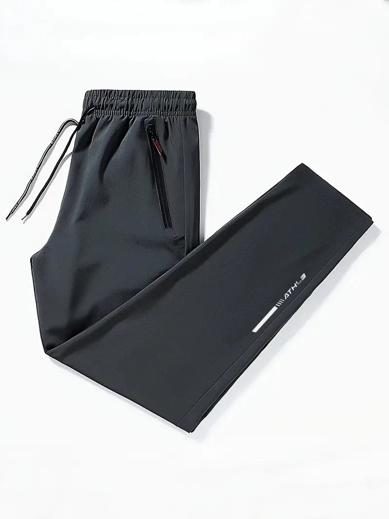 Black drawstring pants on a white background