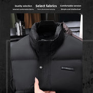 A black puffer jacket with a high collar and snap-button front, shown on a hanger with a hand holding the hem area. The image includes marketing text at the top and a dark textured background.