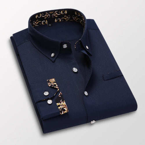 Folded navy blue shirt with gold accents on a light gray background
