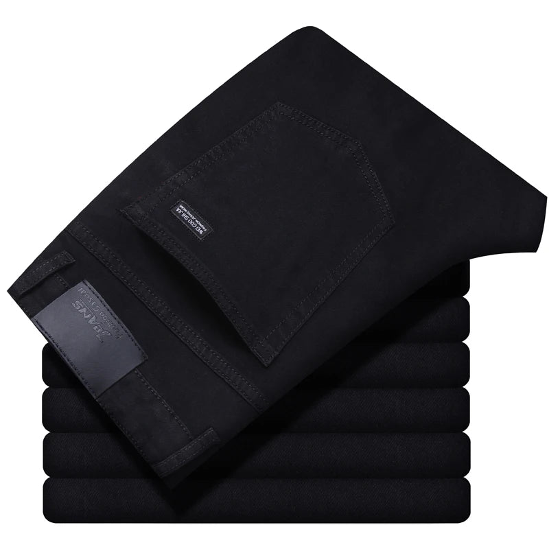 Stack of black pants with a brand label on a white background