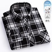 Folded black and white plaid shirt with a label indicating 100% cotton on a white background.