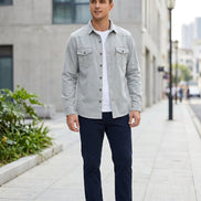 Light gray button-up shirt with two front pockets on a white background