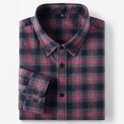 A folded long-sleeve plaid button-down shirt in navy and pink, shown on a clean white background.
