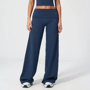 Person wearing navy blue athletic pants and top on a white background