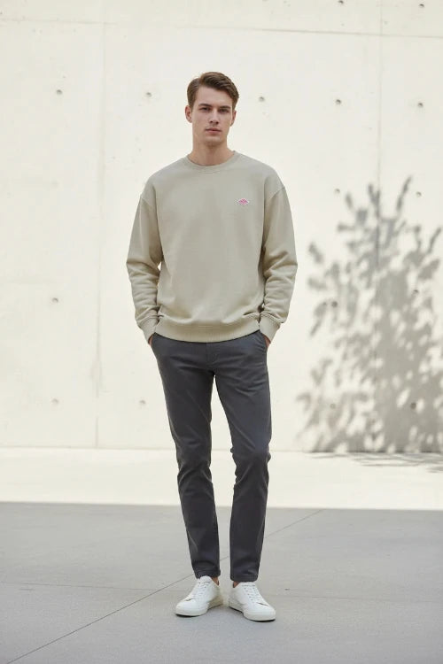 Beige sweatshirt with a small logo on a white background