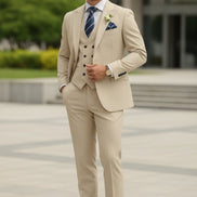 Beige suit with a blue tie and pocket square on a white background