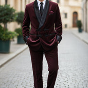 Maroon velvet suit with quilted lapels on a wooden background
