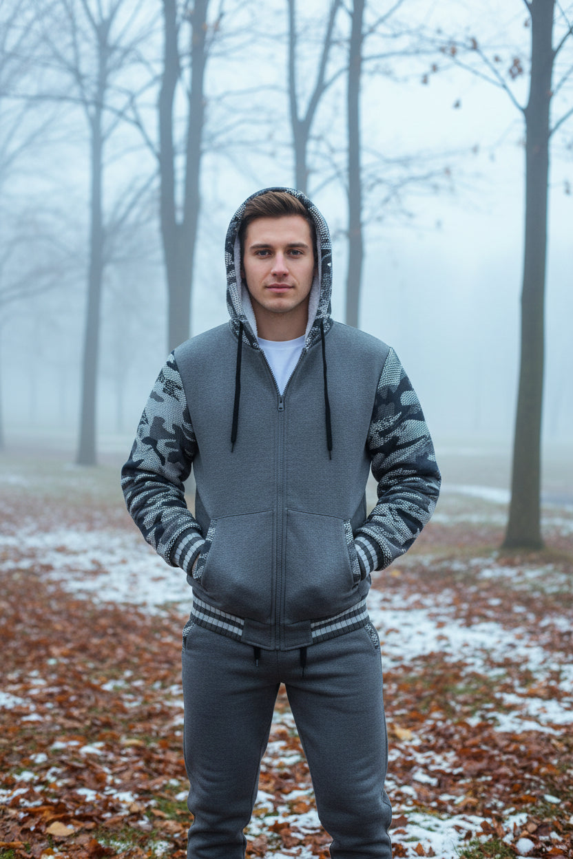 Gray hoodie and pants set with camouflage pattern on sleeves against a white background