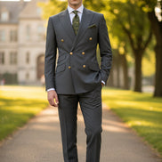Gray suit jacket with gold buttons and matching pants on a white background