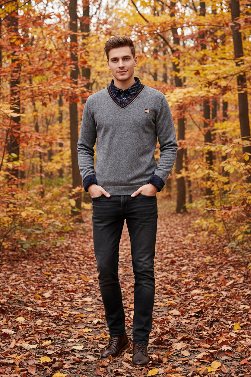 Folded gray fleece pullover with patterned collar on a white background