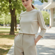 Beige long-sleeve top worn by a person against a neutral background