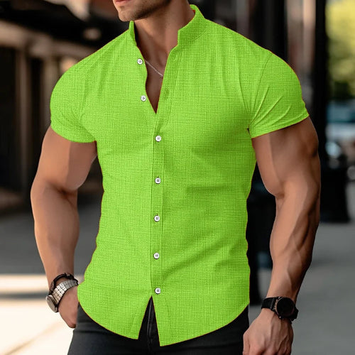Person wearing a bright green short-sleeve shirt with a blurred background