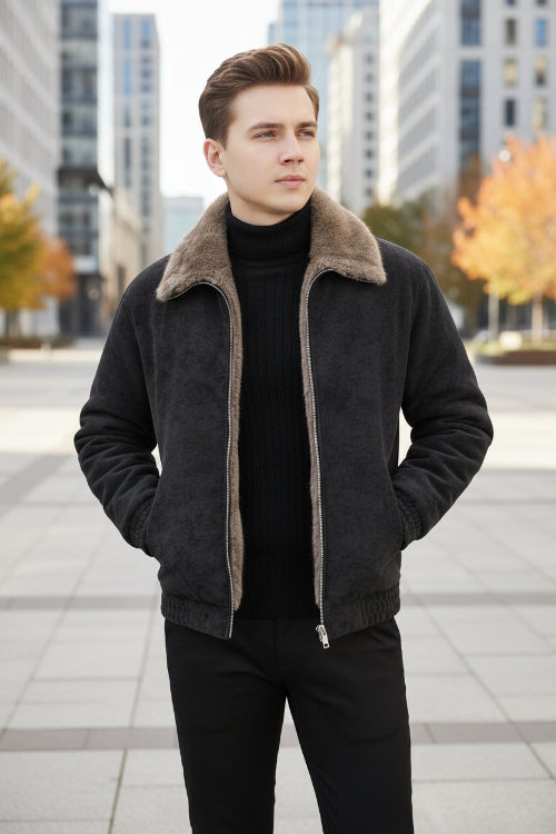 A man wearing a dark gray faux-suede jacket with a brown sherpa lining, opening the jacket to show the warm interior. A graphic of a burning flame is shown in the bottom right corner.