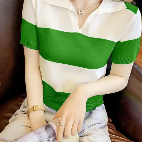 A woman wearing a short-sleeve knit polo shirt with bold green and white horizontal stripes, seated on a brown leather chair.