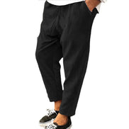 Black pants worn by a person on a white background
