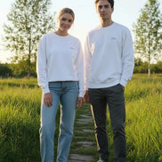 A white crewneck sweatshirt with a small gray 'Dunc' logo printed on the left chest, displayed flat against a solid white background.