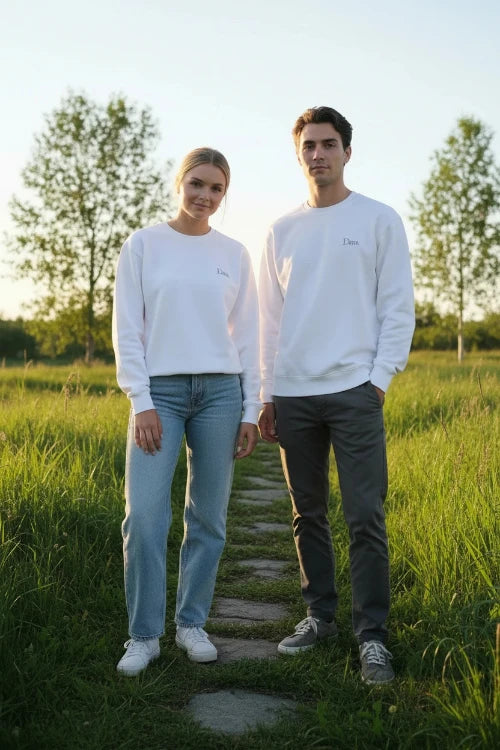 A white crewneck sweatshirt with a small gray 'Dunc' logo printed on the left chest, displayed flat against a solid white background.