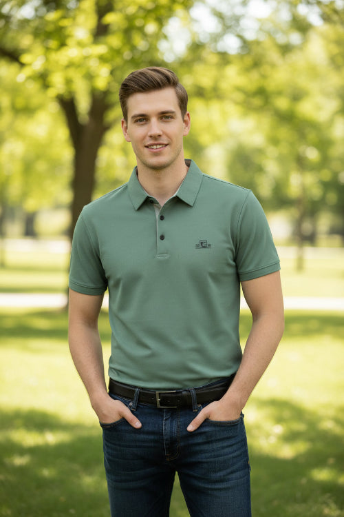 Green polo shirt on a hanger with a hand touching it, brand label visible