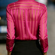 Pink sheer striped shirt worn by a model, shown from the back.