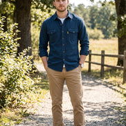 Blue button-up shirt with rolled-up sleeves on a white background