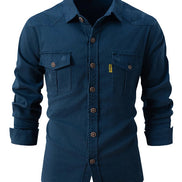 Blue button-up shirt with rolled-up sleeves on a white background