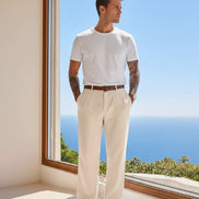 Person wearing beige pants with a blurred scenic background