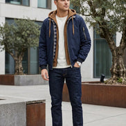 Navy blue jacket with brown hood and plaid lining on a white background