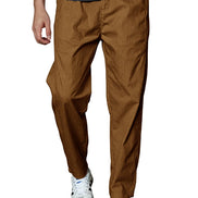 A person wearing brown tapered pants with a dark gray ribbed t-shirt and white sneakers, shown from the waist down against a plain white background.