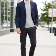 Navy blue dress shoes worn with black pants on a wooden floor