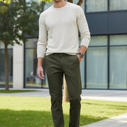 Person wearing green pants with a gray background