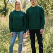 A dark green crewneck sweatshirt with a small purple embroidered 'Dime' logo on the left chest, displayed flat against a solid white background.