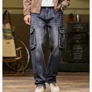 Front view of a model wearing faded dark blue cargo pants with large flap thigh pockets and loose straight legs, paired with light-colored sneakers.