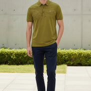 A close-up of a textured olive green short-sleeve polo shirt on a black hanger, with a hand pointing to the left chest area where a small white 'NEWSPORT' logo is embroidered.