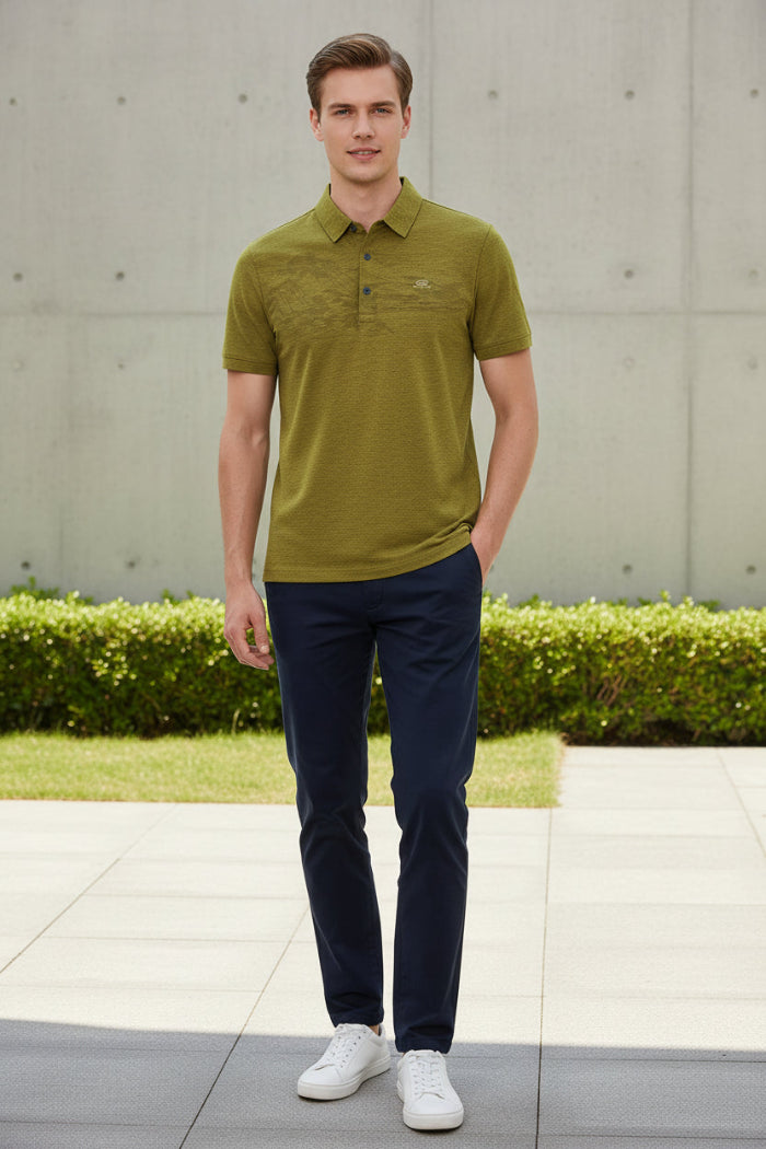 A close-up of a textured olive green short-sleeve polo shirt on a black hanger, with a hand pointing to the left chest area where a small white 'NEWSPORT' logo is embroidered.