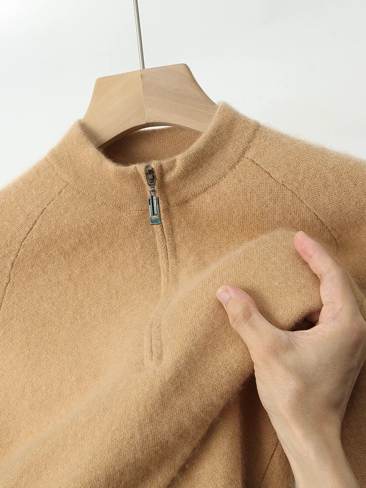 Beige fleece jacket on a hanger with a hand touching the fabric