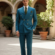 Man in a blue suit with a green tie and pocket square in a bar setting