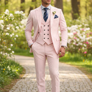 Pink suit with a striped tie and boutonniere on a white background