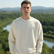 Beige sweatshirt with a small logo on a white background