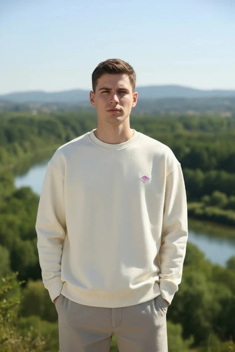 Beige sweatshirt with a small logo on a white background